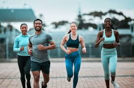 Sculpting Sleek Arms: The Essential Role of Cardio in Toning Without Bulking Up 3 image of people running to incorporate cardio Chigwell exercise into their life to help tone arms and body.